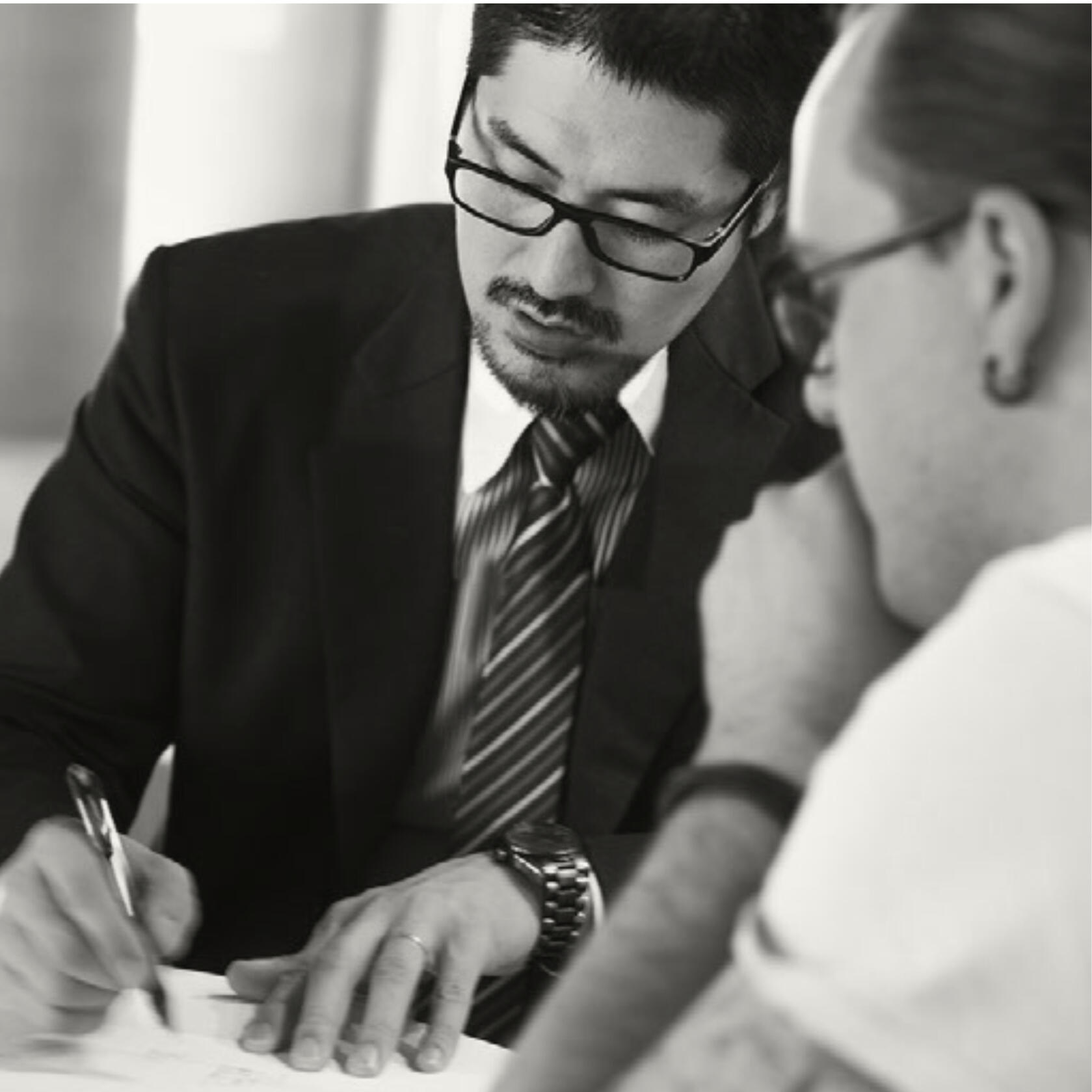 Japanese businessmen speaking, sketching on paper, from Japan Advertising and Media Buying Experts